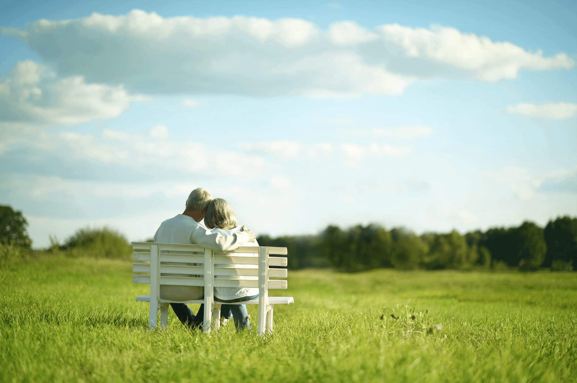 old couple sitting looking at clouds