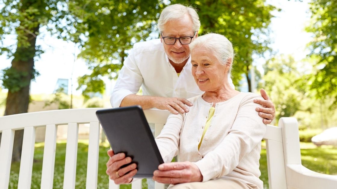 senior couple shopping for final expense policies with tablet